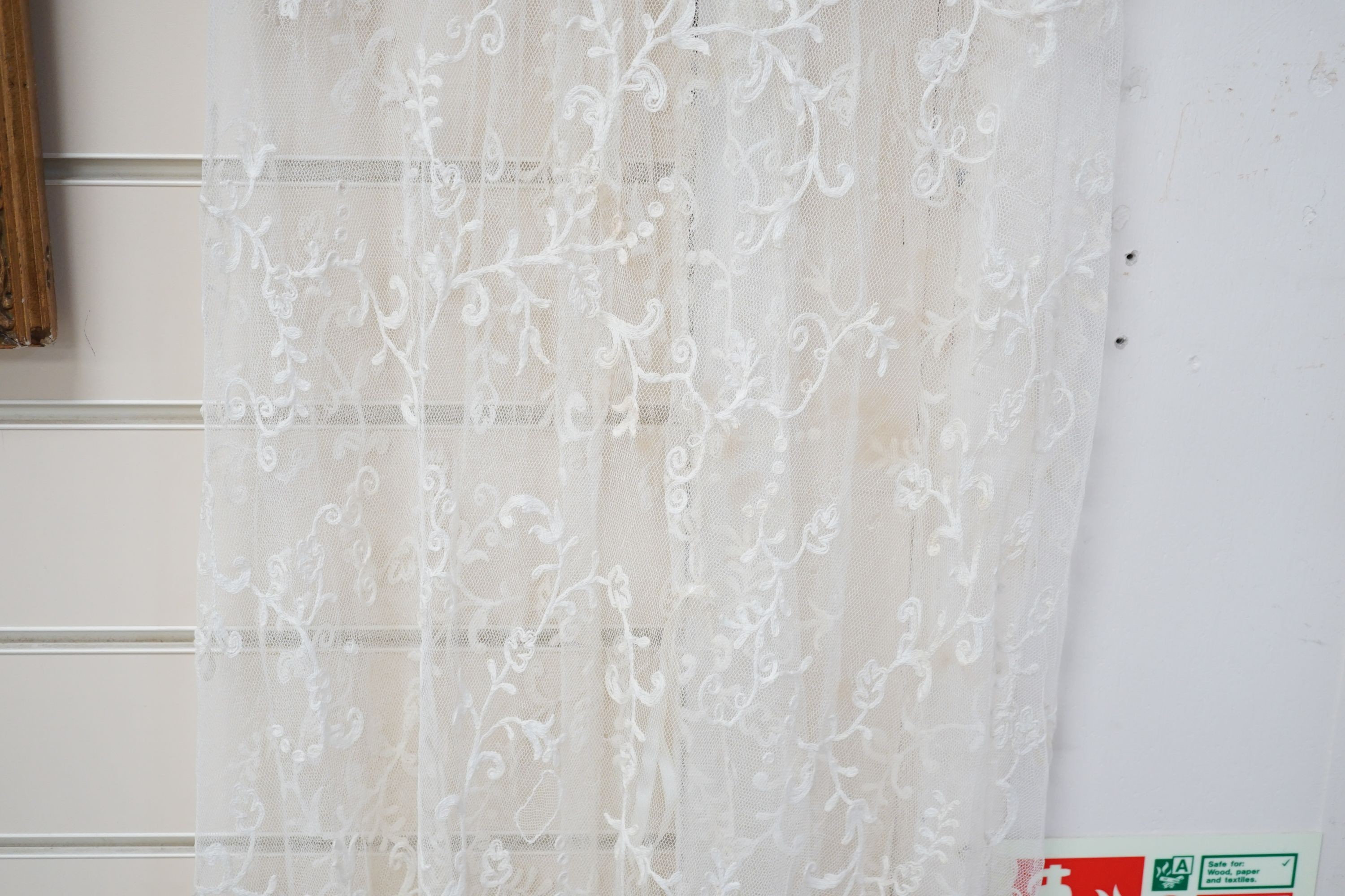 An early 20th century needle run on net lace wedding dress, 155 cms long.